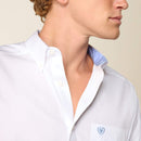 Men's Ariat White long sleeve wrinkle free shirt. Close up of Light Blue contrast band inside button down collar. Also features a close up view of the left chest pocket featuring a Light Blue Ariat logo.