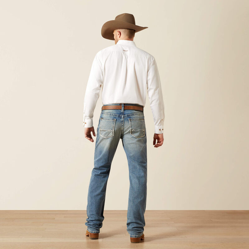 Men's Ariat M4 relaxed fit boot cut jean in a light wash. Rear view