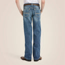 Boys Ariat B4 relaxed fit boot cut jeans in a medium wash. Rear view showing stitching details on back pockets. 