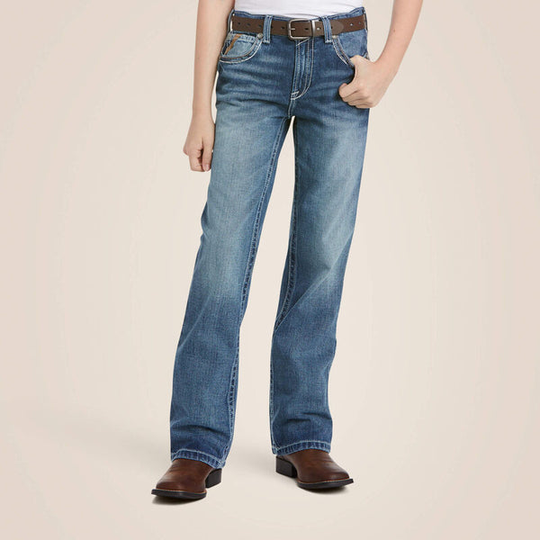 Boys Ariat B4 relaxed fit boot cut jeans in a medium wash. Font view