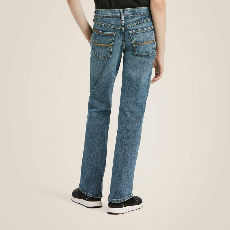 Boy's Ariat M5 slim straight jeans, in a medium wash. 
