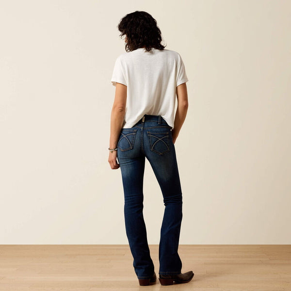 Women's Ariat perfect rise boot cut jeans in a dark wash.  Rear view showing jeans on model. 