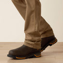 Right view of men's Ariat khaki Rebar pants showing hem and how pants fit over work boots. 
