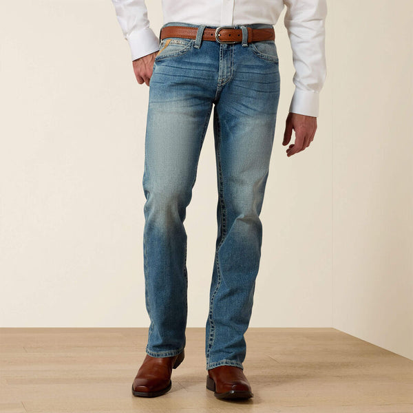Men's Ariat M7 slim fit straight leg jeans in a light wash. Front View