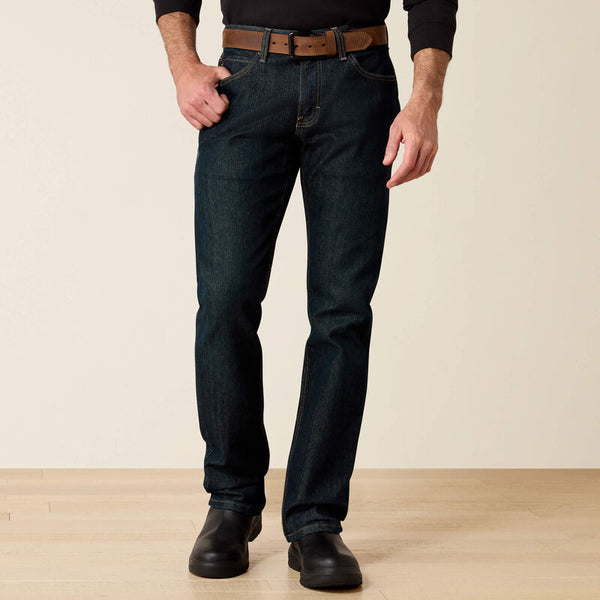 Men's Ariat Rebar M7 slim straight work jeans, in Blackstone a dark wash. Front view showing jeans on a model. 