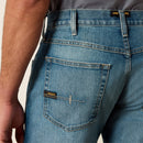 Men's Ariat M5 Rebar work jeans in Edgewood, a light wash. Rear view showing  a close up of the pocket stitching and Ariat logo patch. 