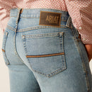 Men's Ariat M7 straight jean in a light wash. Rear view showing back pocket stitching and Ariat Denim logo patch. 