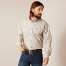 Men's Ariat long sleeve button down shirt in Bandshell, a tan color with a print of steer skulls. Front view showing shirt tucked in. 
