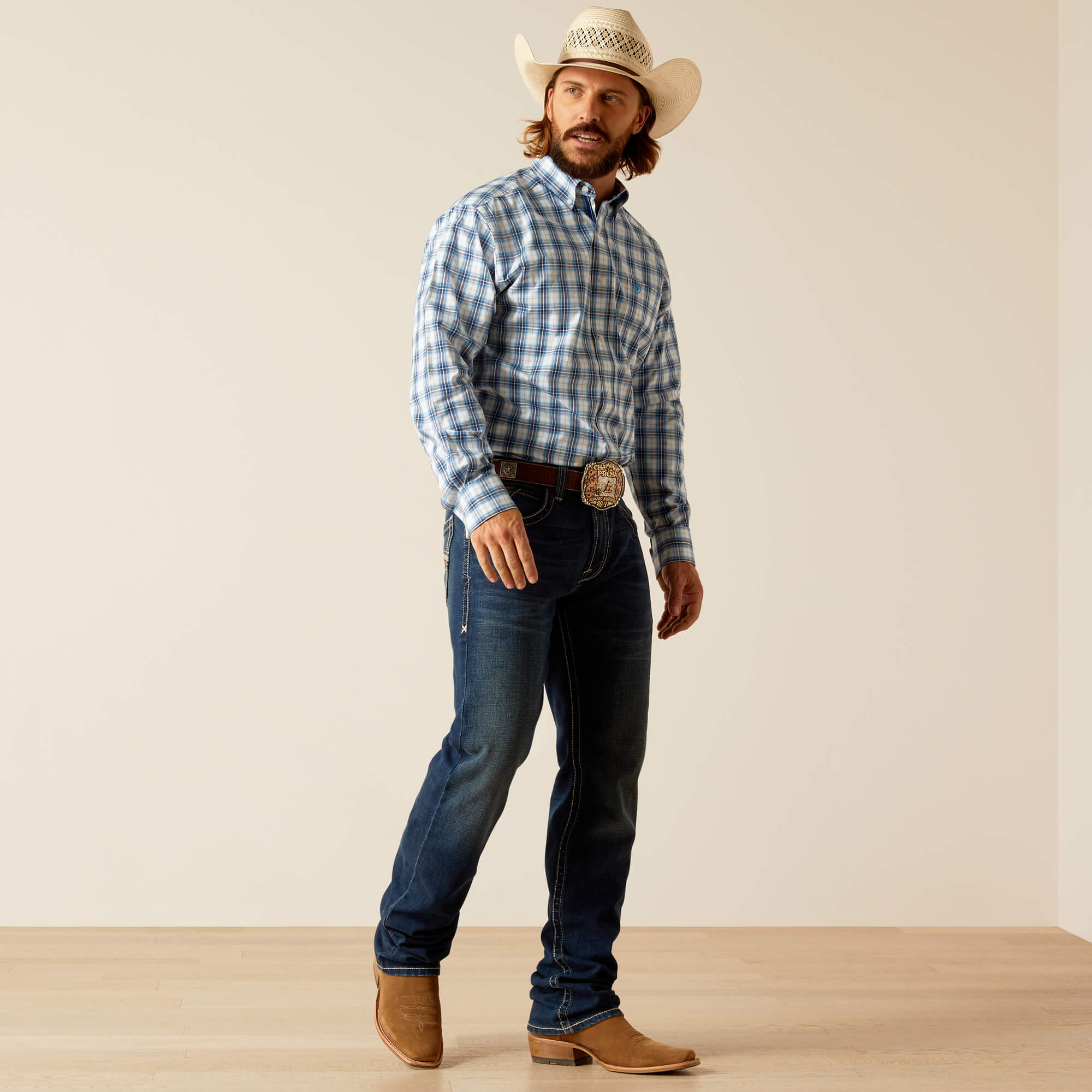 Men's Ariat long sleeve shirt in Blue Plaid. Side view showing shirt tucked in. 