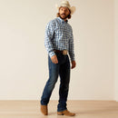 Men's Ariat long sleeve shirt in Blue Plaid. Side view showing shirt tucked in. 