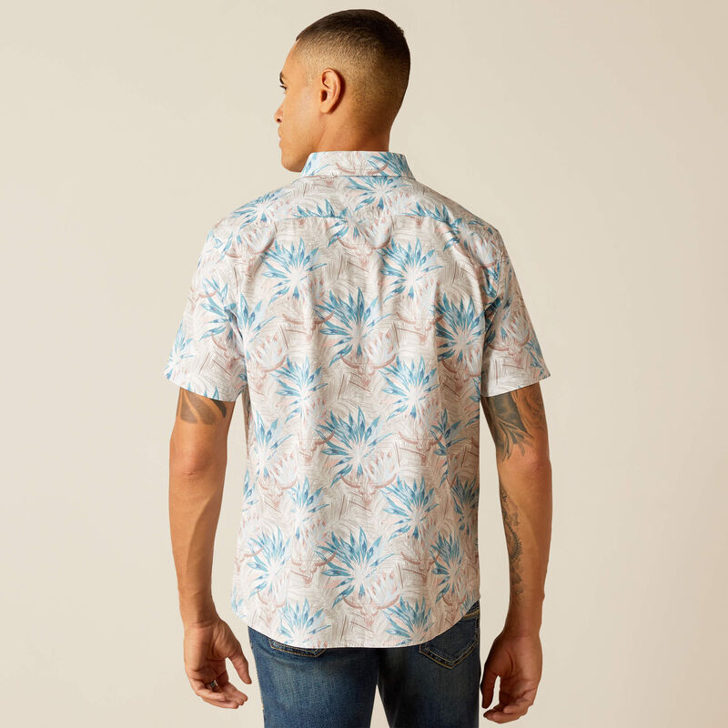 Men's Ariat short sleeve shirt in Moonbeam featuring a tropical floral cow skull pattern. This shirt is a modern fit and can be worn untucked. Rear view showing shirt untucked. 
