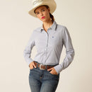 Women's Ariat long sleeve wrinkle resistant stretch shirt in True Blue. This Western style shirt is a blue and white pinstripe. Front view showing shirt tucked in and Ariat shield logo on left chest pocket. 