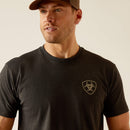 Men's Ariat short sleeve graphic tee in Charcoal Heather. Close up front view showing Ariat shield logo graphic on left chest. 