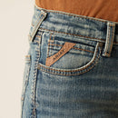 Boy's Ariat B5 slim straight jean in a medium wash. Close up of pocket showing Ariat logo tag. 