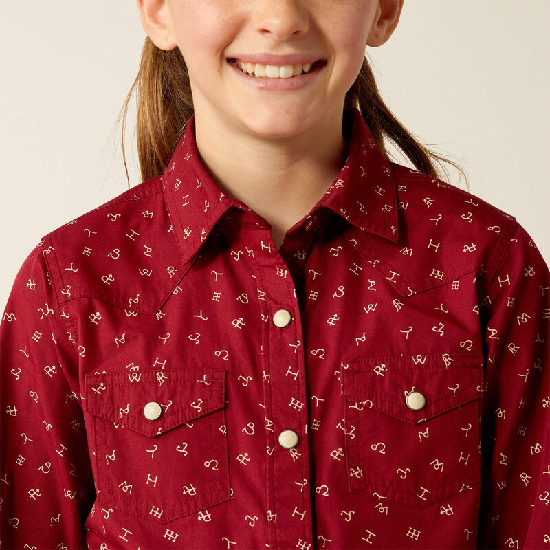 Girl's Ariat snap closed long sleeve Western Style shirt in Red Ranch. This shirt features brand logos and twosnap close pockets on chest. Close up of chest pockets and collar. 