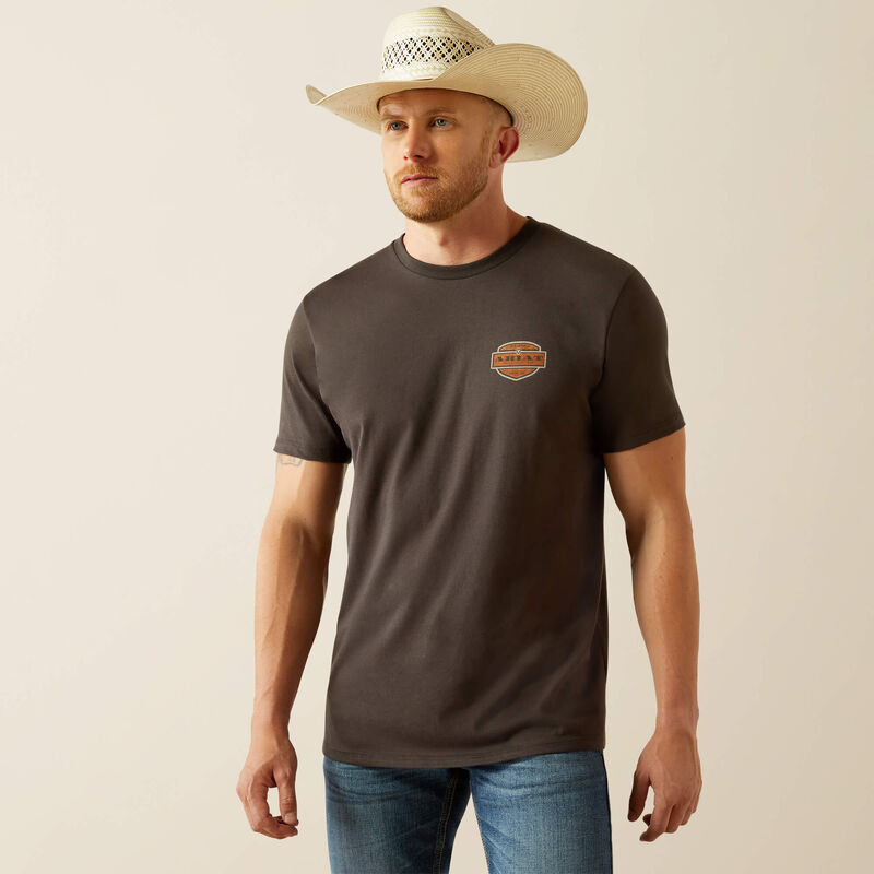 Men's Ariat graphic logo short sleeve tee in Vintage Black. Front view showing shirt untucked with Ariat log on left chest. 