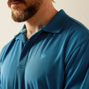 Men's Ariat Tek short sleeve polo shirt in Blue Sapphire. Close up of collar and chest showing Ariat shield logo. 