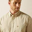 Men's Ariat long sleeve shirt in a Cream/Light Brown pattern. Shirt features button close and a bold Ariat logo on left sleeve. Close up of chest showing Ariat shield logo on pocket. 