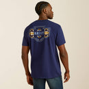Men's Ariat logo short sleeve tee in Medieval Blue. Model is wearing shirt untucked and shows the back design. 
