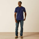 Men's Ariat logo short sleeve tee in Medieval Blue. Full front view of model wearing shirt untucked. 