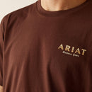 Men's Ariat short sleeve tee in Deep Mahogany, with a cowboy design on back with "They hate us cause they ain't us". Close up of front chest showing Ariat Western Gear logo. 