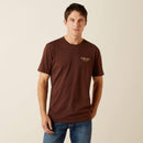 Men's Ariat short sleeve tee in Deep Mahogany, with a cowboy design on back with "They hate us cause they ain't us". Front view shirt is untucked. 