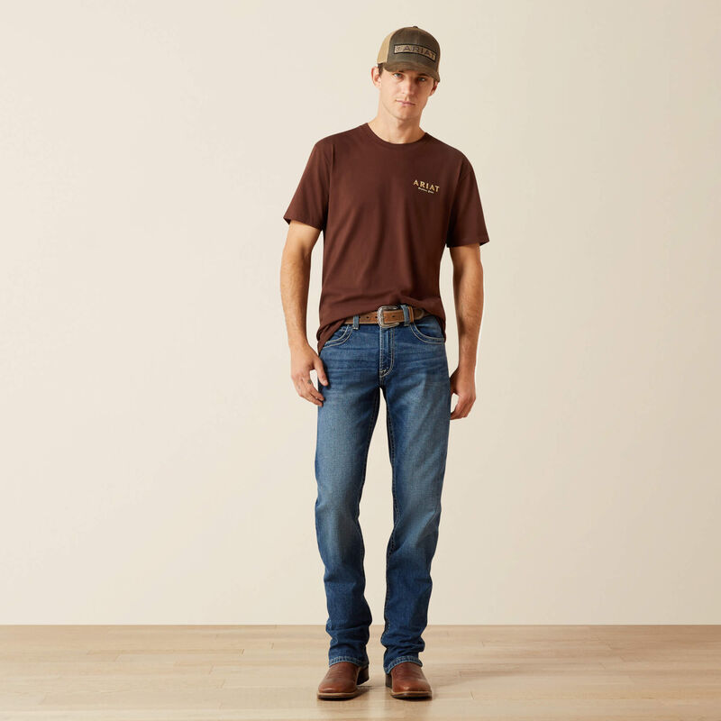 Men's Ariat short sleeve tee in Deep Mahogany, with a cowboy design on back with "They hate us cause they ain't us". Full front view