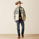 Men's Ariat Softshell jacket in White Pepper Southwest. This jacket has a solid beige bottom and a Southwestern pattern on the top of the front made of blue and browns. It has a zippered close and a bold Ariat logo on left sleeve. The back is soild beige. Front view jacket unzipped. 