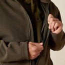 Ariat men's softshell jacket in Earth Green Heather. This jacket features a bold Ariat logo on the left sleeve in brown. Close up of front inside zippered pocket. 