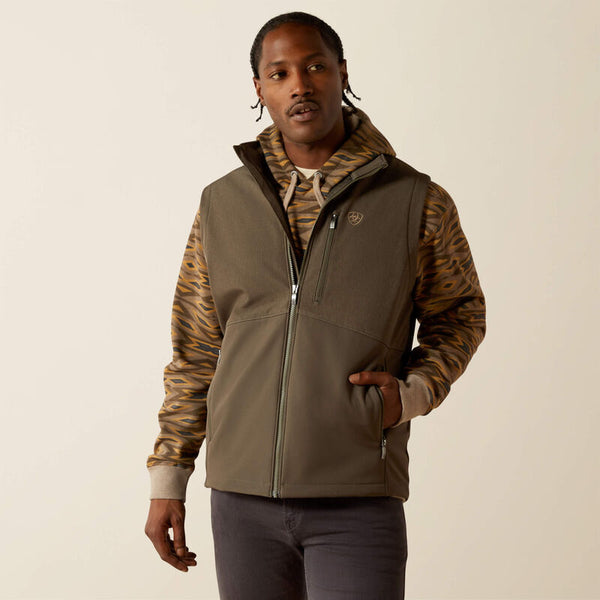 Men's dark green heather weather resistant vest. Has full front zipper, standing collar, left chest vertical zippered phone pocket bearing an Ariat logo, slash zippered hand pockets, Hit mid hip. Front view.
