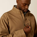 Closeup front view of left chest showing concealed zipper pocket and wind stopping front zipper lining. Also shows closeup of sleeve khaki tonal geometric pattern and solid chest and yoke areas.