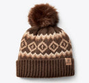 Brown knit beanie with a patterned design and fur pom-pom. Small Ariat logo leather patch on band.