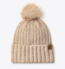 Beige knit beanie with a fur pom-pom with small Ariat logo leather patch on band.