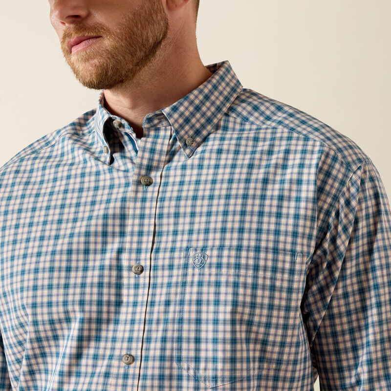 Men's Ariat Pro Series long sleeve shirt in Deep Dive Plaid. Close up view of button down collar and Ariat shield logo on left chest pocket. 
