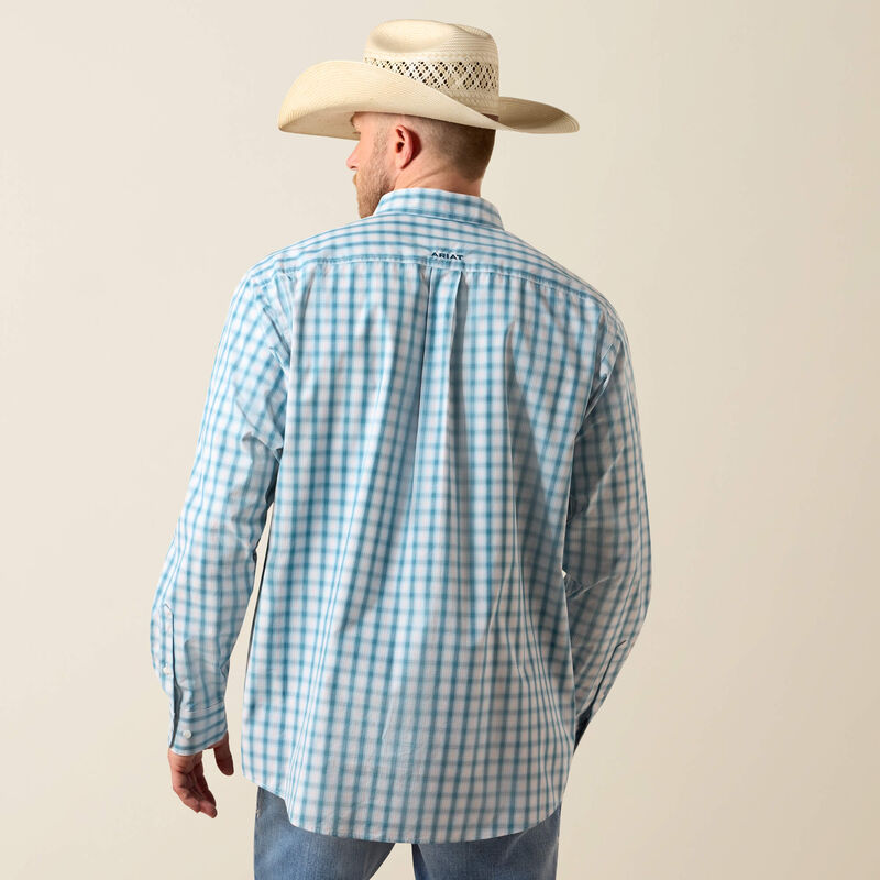 Men's Ariat long sleeve shirt in Corsair Plaid, a blue plaid pattern. Rear view showing shirt untucked. 