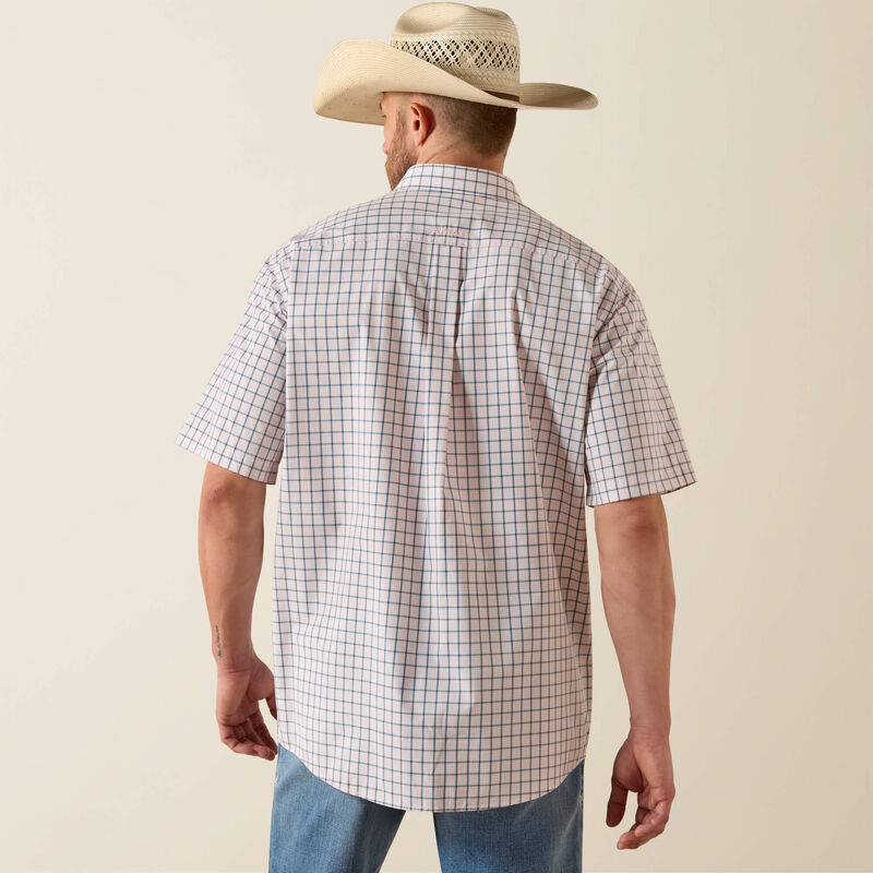 Man wearing a checkered shirt and cowboy hat on a beige background