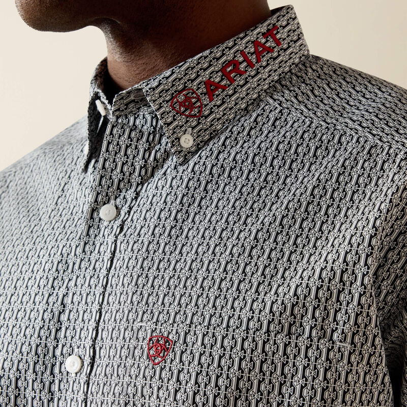 Close-up of a patterned shirt with Ariat logo on collar and chest.