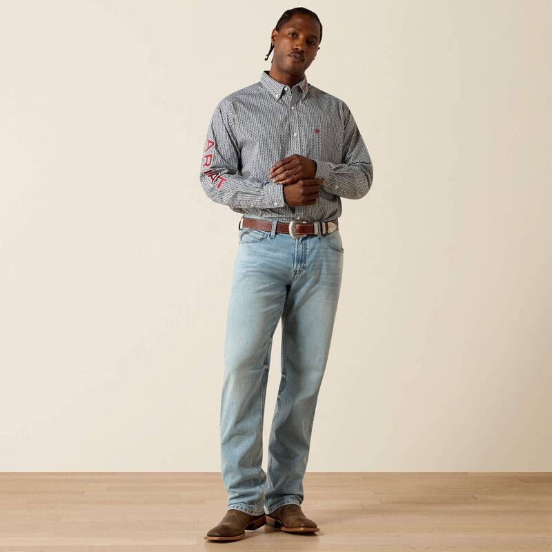 Man wearing a checkered shirt with 'ABZ' on sleeves and light blue jeans against a beige background