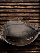 This Brown tooled leather and cowhide purse features a removable adjustable shoulder strap and a zippered closed concealed carry pocket on the rear. Inside it has six card slots and a zippered closed pocket. Inside View 