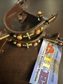 Men's brown spurs with copper and brass accents. 