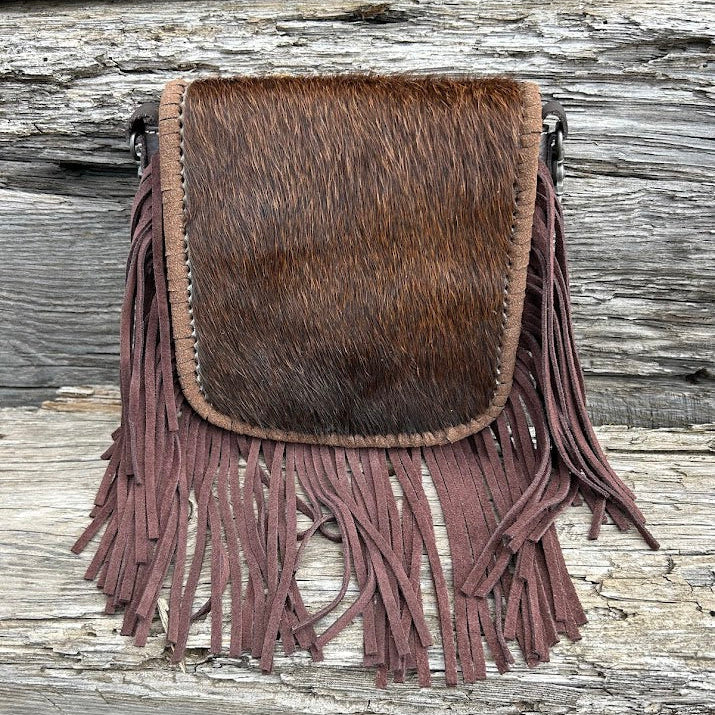 This cowhide and fringe crossbody bag in Coffee Brown leather has a removable and adjustable strap. Front View A