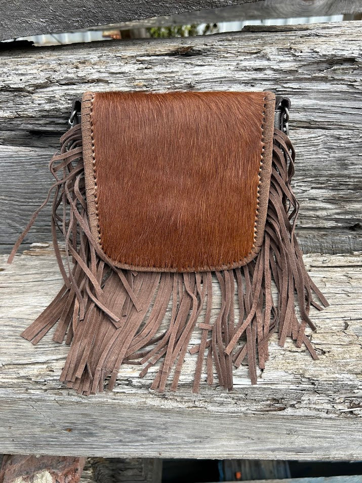 This cowhide and fringe crossbody bag in Coffee Brown leather has a removable and adjustable strap. Front View B