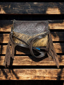 This Brown tooled leather and cowhide purse features a removable adjustable shoulder strap and a zippered closed concealed carry pocket on the rear. Inside it has six card slots and a zippered closed pocket. Front View D