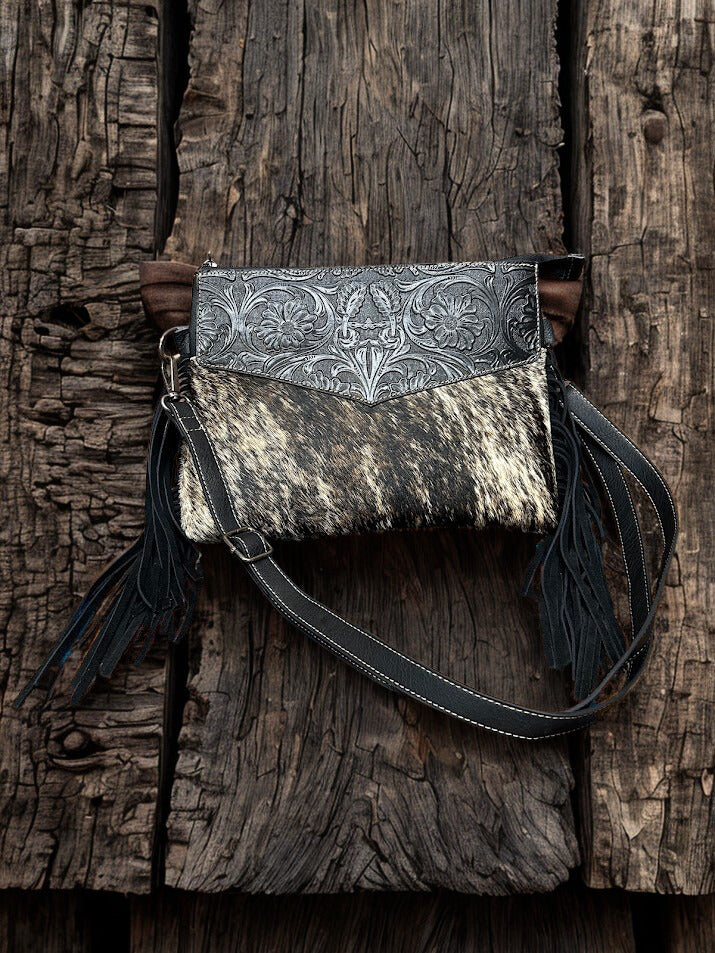 This Black tooled leather and cowhide purse features a removable adjustable shoulder strap and zippered close concealed carry pocket on the rear. Front View A