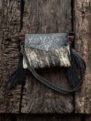 This Black tooled leather and cowhide purse features a removable adjustable shoulder strap and zippered close concealed carry pocket on the rear. Front View A