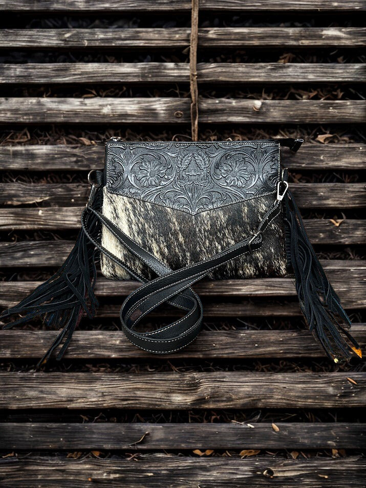 This Black tooled leather and cowhide purse features a removable adjustable shoulder strap and zippered close concealed carry pocket on the rear. Front View  B