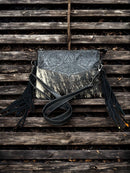 This Black tooled leather and cowhide purse features a removable adjustable shoulder strap and zippered close concealed carry pocket on the rear. Front View  B