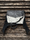 This Black tooled leather and cowhide purse features a removable adjustable shoulder strap and zippered close concealed carry pocket on the rear. Front View D