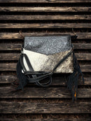 This Black tooled leather and cowhide purse features a removable adjustable shoulder strap and zippered close concealed carry pocket on the rear. Front View E