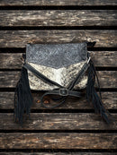 This Black tooled leather and cowhide purse features a removable adjustable shoulder strap and zippered close concealed carry pocket on the rear. Front View F